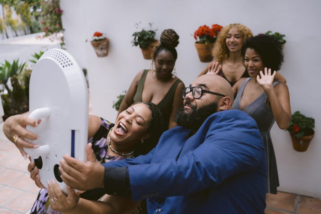 Guests laughing while taking photos together