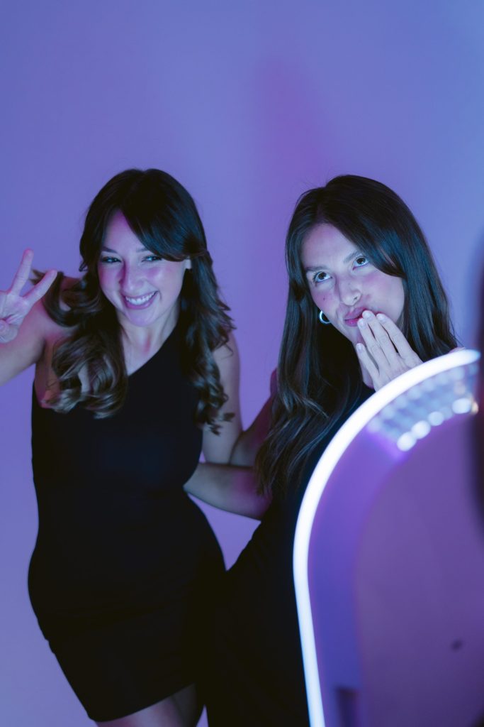 Two guests posing together at a photo booth