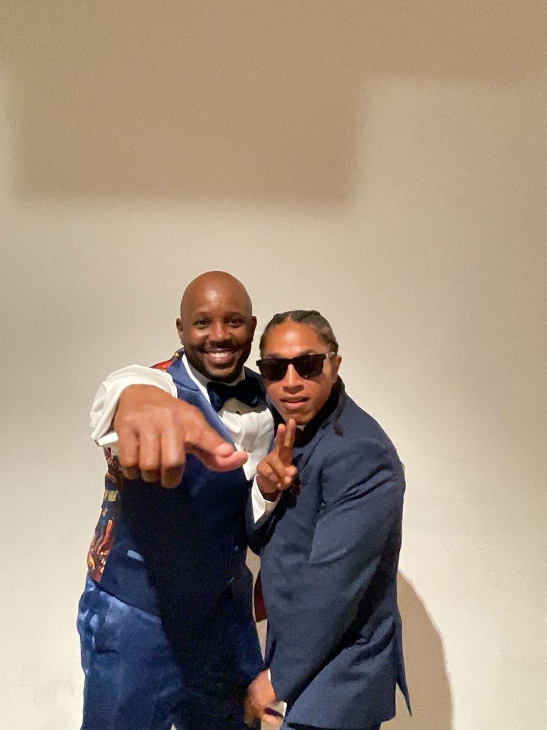 Two guests striking a fun pose at an event