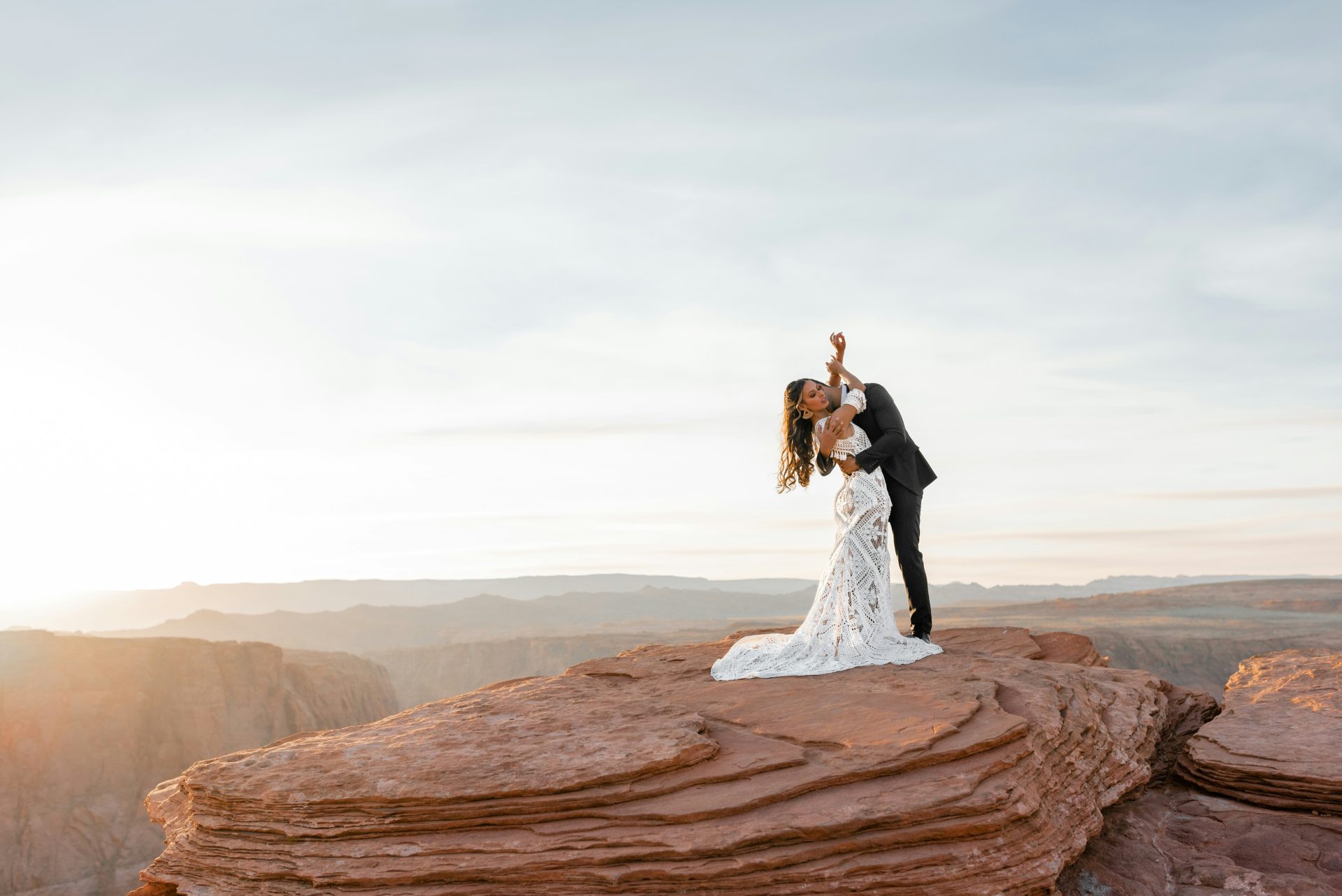 man and woman kissing on brown rock formation during daytime
