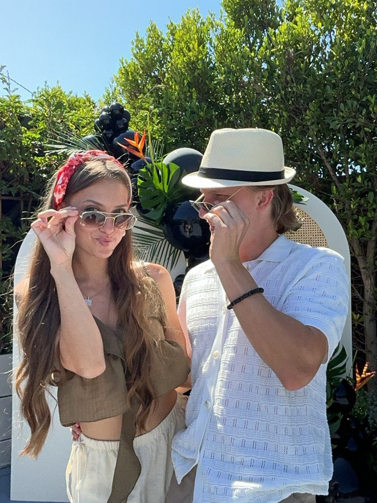 Couple posing playfully at an outdoor event